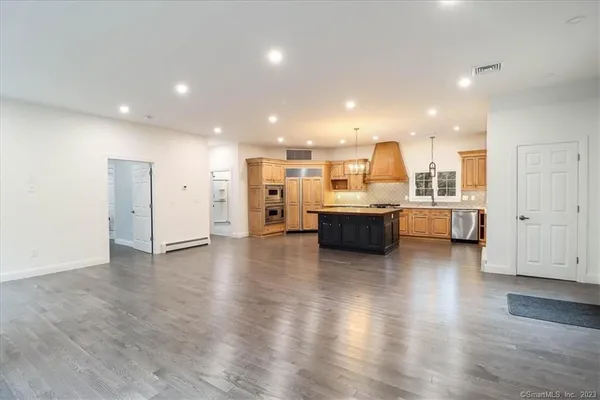 a open kitchen with a sink and a stove top oven