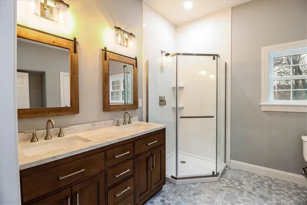 a bathroom with a double vanity sink mirror and double