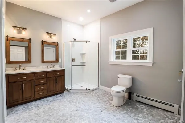 a bathroom with a toilet sink and mirror