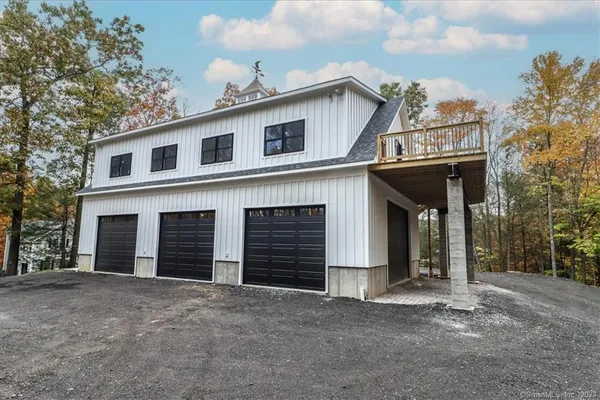 a view of a house with a yard and garage