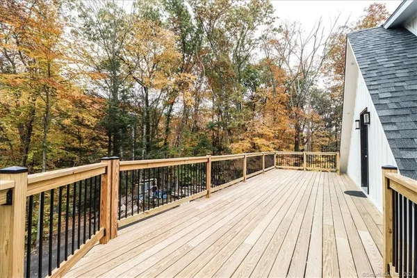 a view of balcony with wooden floor and fence