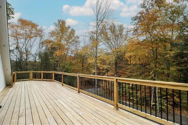 a view of a balcony with wooden floor and fence