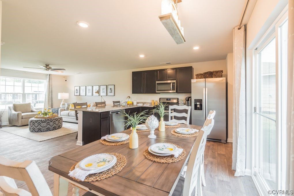2219 Rdg Ml Way Chester, VA 23831 - Photo 7 of 10 a dining room with furniture a chandelier and kitchen view