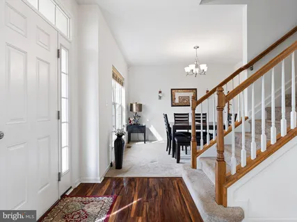 a view of a livingroom with furniture hardwood floor and staircase