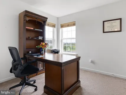 a room with a desk and a workspace