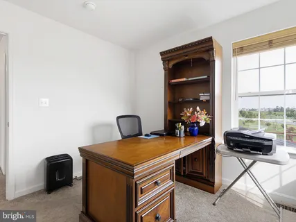a view of a dining room with a table and chairs