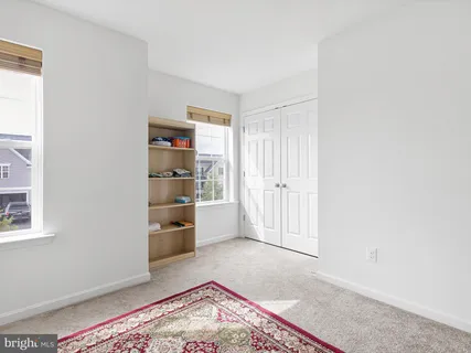 a view of a bedroom with cabinet and a window