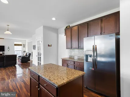 a kitchen with kitchen island a counter top space cabinets and appliances