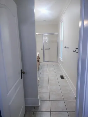 a view of empty room with wooden floor