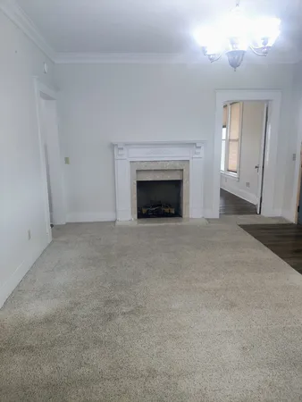 a view of an empty room with a fireplace