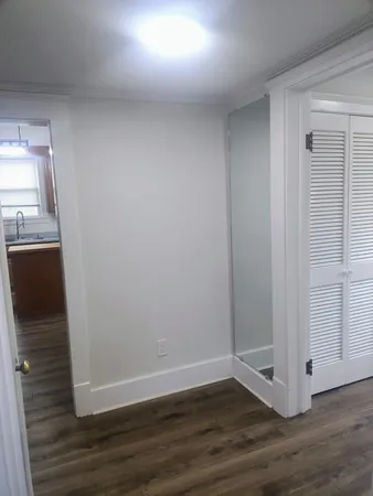 a view of entryway and hall with wooden floor