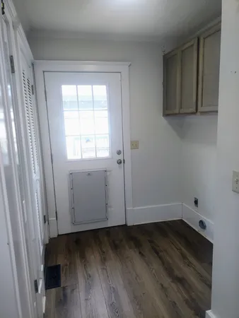 a view of an empty room and wooden floor