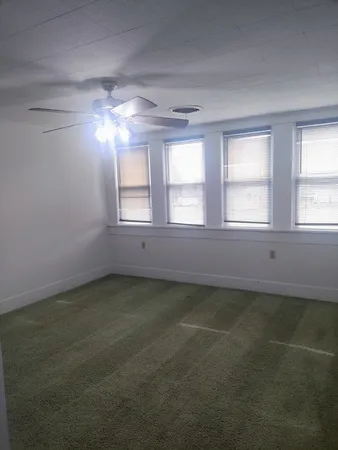 a view of living room with a floor to ceiling window and a rug