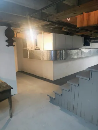 an empty room with windows cabinet and front door