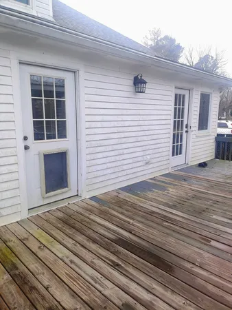 a front view of a house with a yard covered with snow