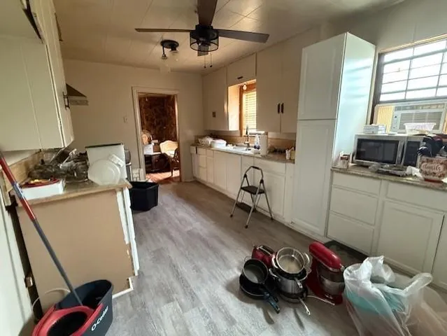 a room with furniture a flat screen tv and a window