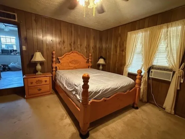 a large bed sitting in a room next to a window