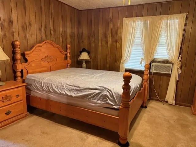 a bed sitting in a spacious bedroom next to a window