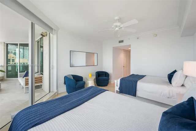 a bedroom with two beds and a chandelier