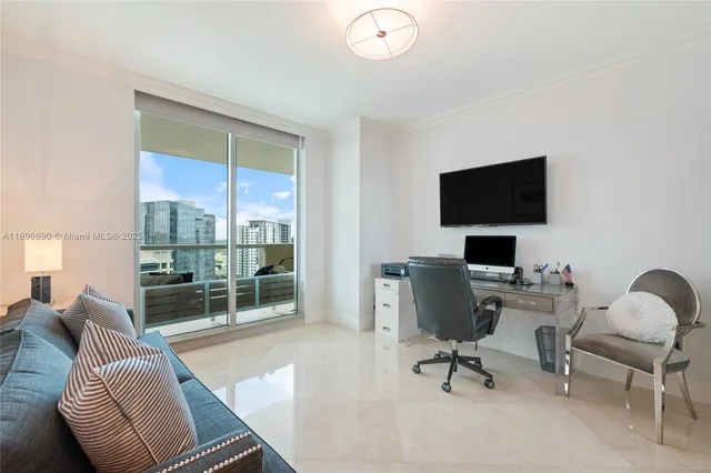 a view of a livingroom with workspace and a window