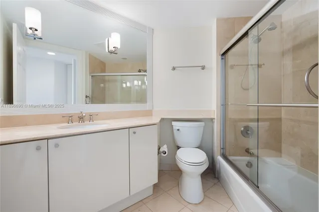 a bathroom with a toilet sink and shower