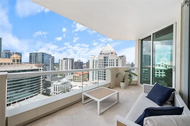a living room with furniture and a floor to ceiling window