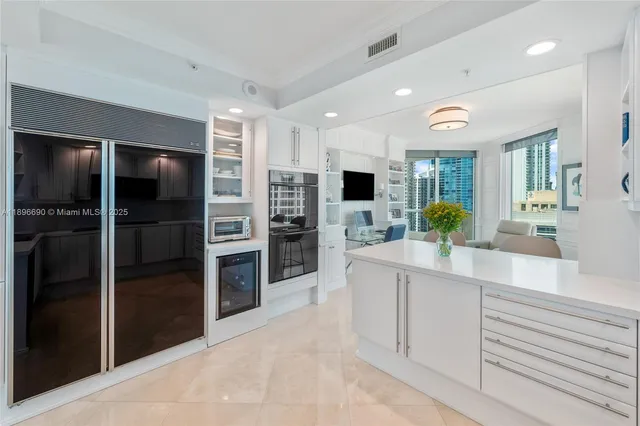 a kitchen with stainless steel appliances a refrigerator and a sink
