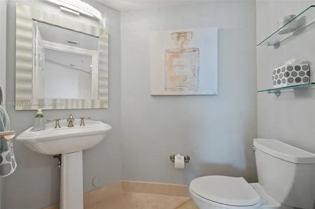 a bathroom with a sink mirror toilet and vanity