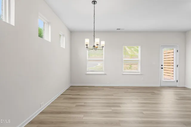 a view of a room window and wooden floor