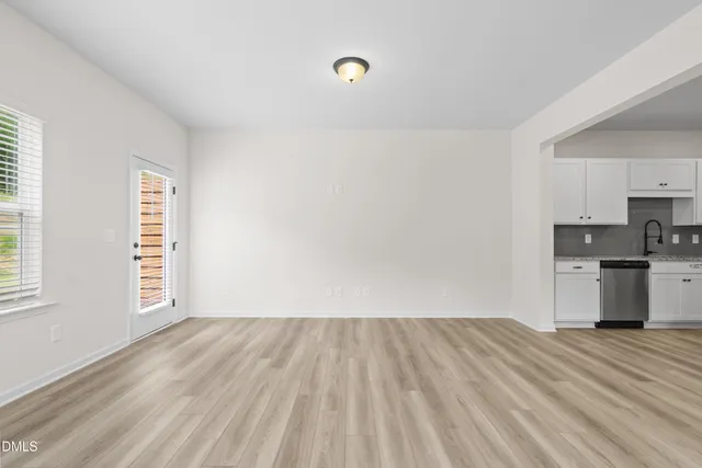 a view of kitchen with wooden floor electronic appliances and window
