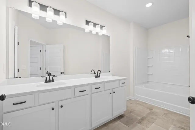 a bathroom with a bathtub and shower