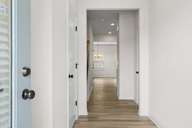 a view of a hallway with wooden floor and closet area