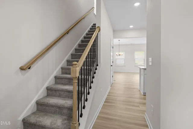 a view of a hallway with wooden floor and entryway