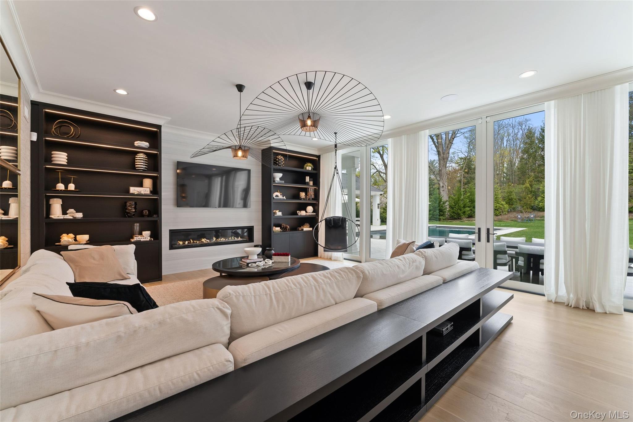 17 Oxford Road Scarsdale, NY 10583 - Photo 11 of 49 Family room with floor to ceiling windows and views of the backyard