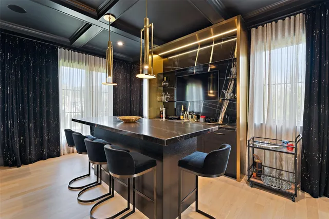 a kitchen with a sink and chairs