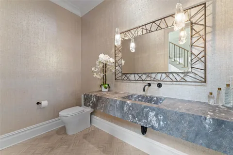 a bathroom with a sink a toilet and a mirror