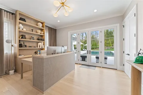 a living room with furniture a large window and chandelier