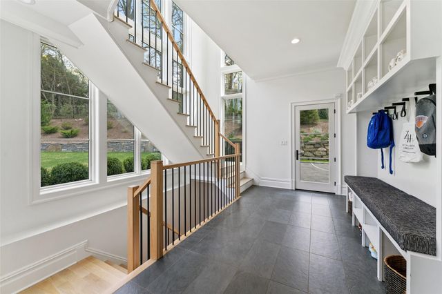 a view of entryway and hall with wooden floor