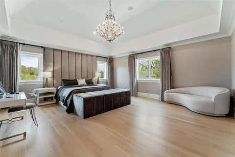 a bedroom with a bed and a chandelier