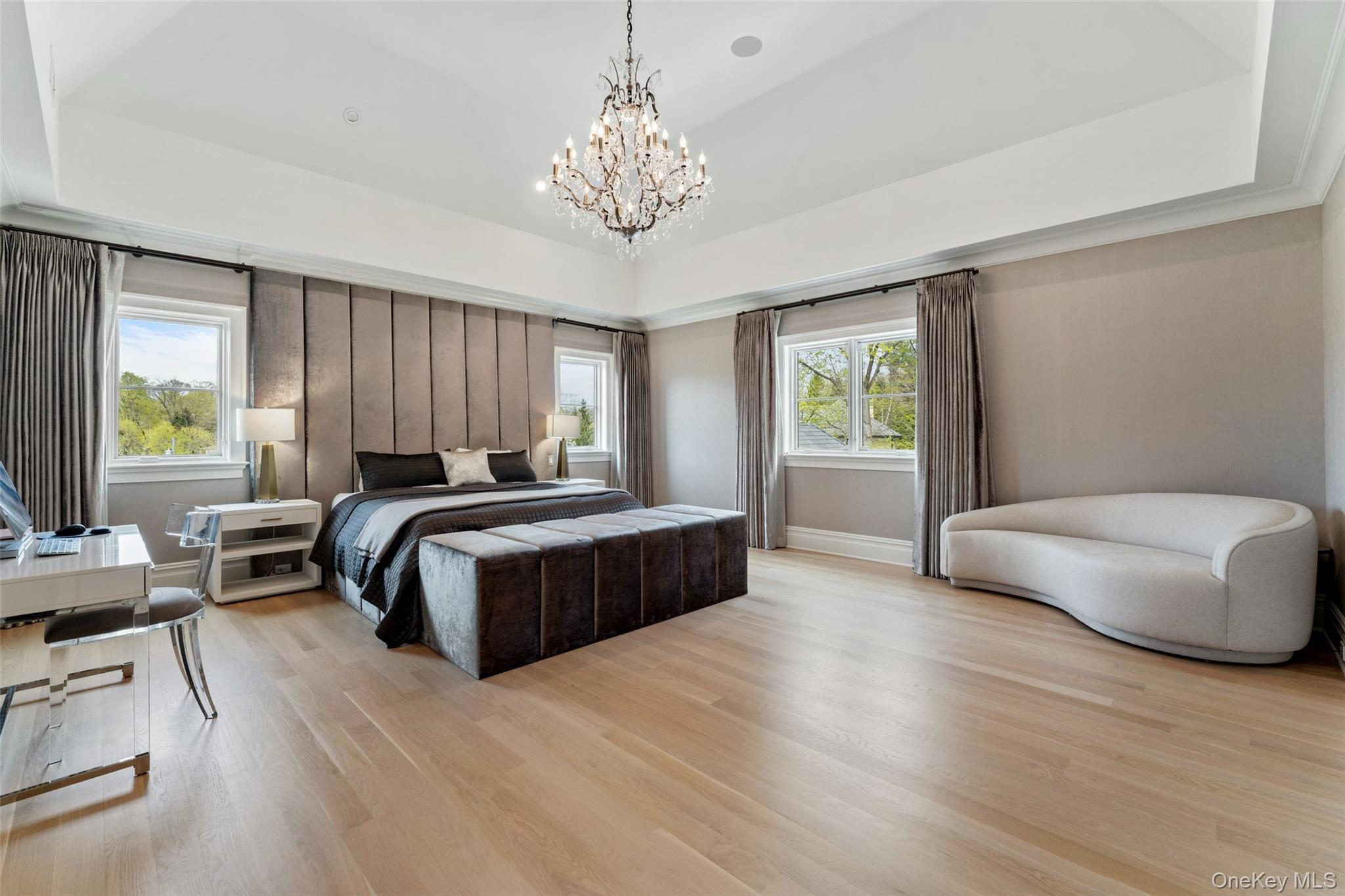 17 Oxford Road Scarsdale, NY 10583 - Photo 21 of 49 Primary suite with vaulted ceilings and floor to ceiling tufted headboard and bench