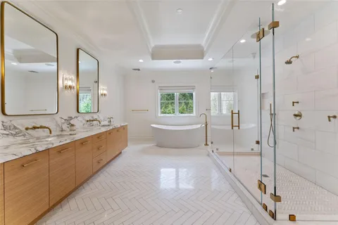 a bathroom with a double vanity sink a mirror and a shower