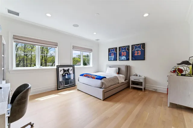 a bedroom with a bed and a large window