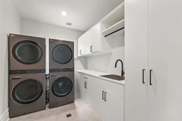 a utility room with sink dryer and washer