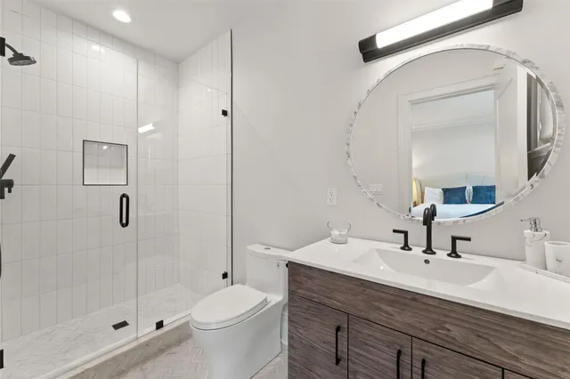 a bathroom with a sink a toilet and shower