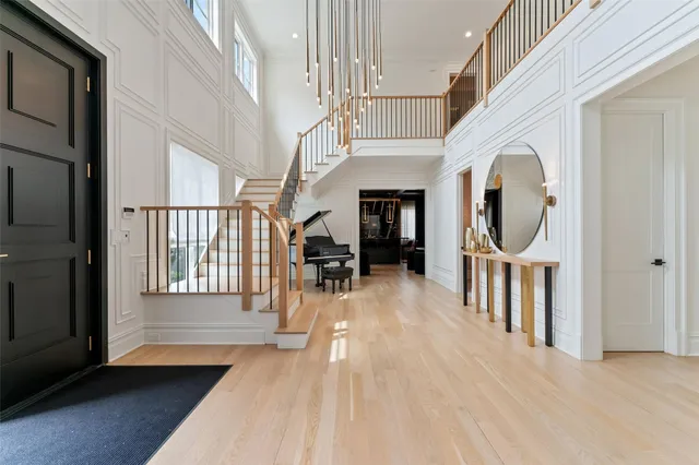 a view of a hallway with wooden floor windows and a kitchen view