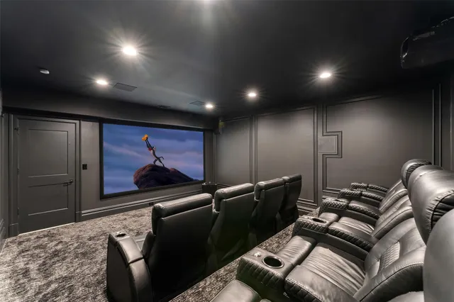 a media room with lots of chairs and a projector