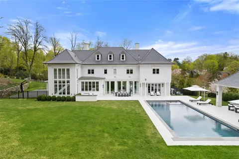 a view of a house with a swimming pool and a chairs