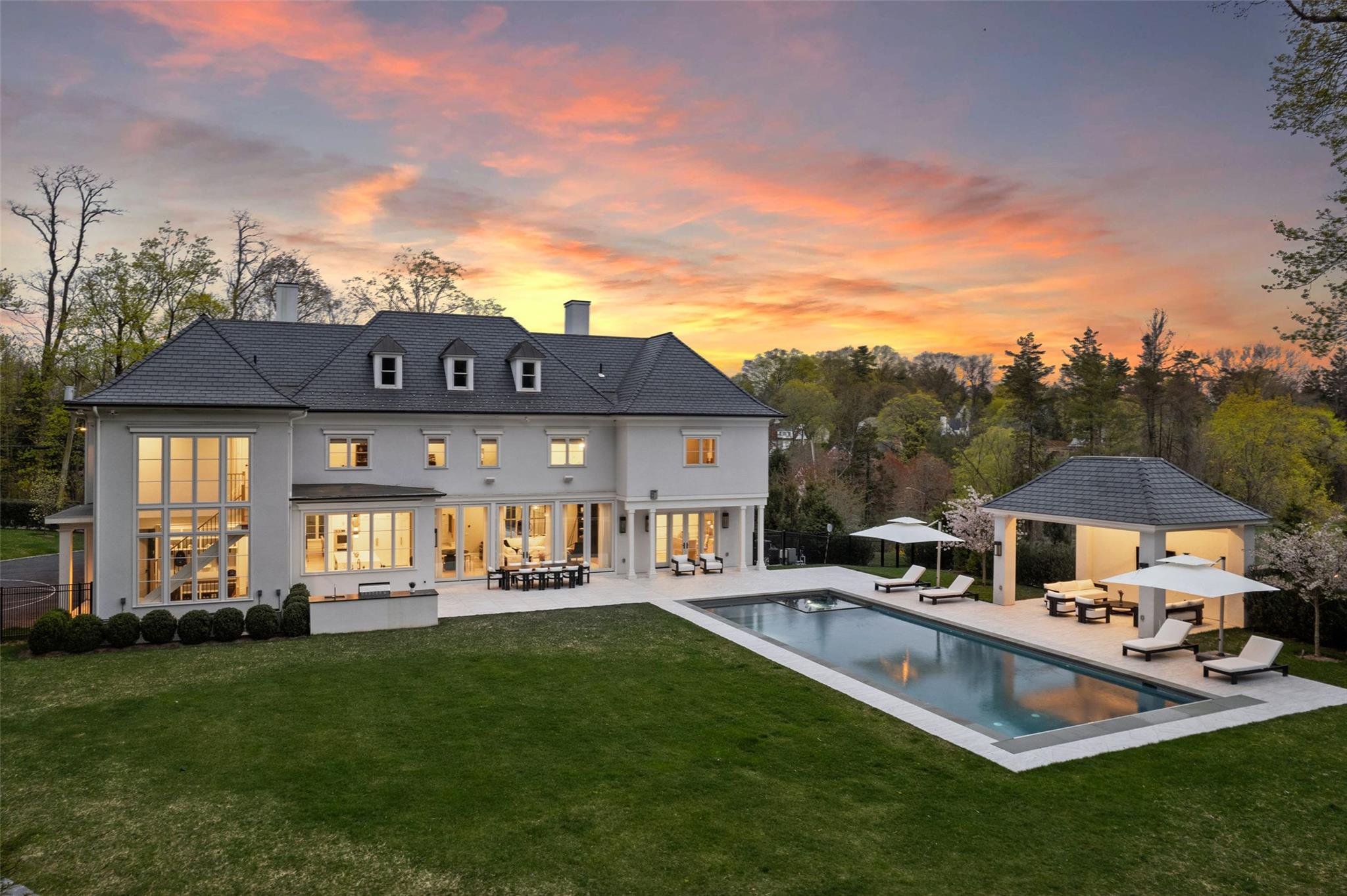 17 Oxford Road Scarsdale, NY 10583 - Photo 40 of 49 a front view of a house with a yard table and chairs