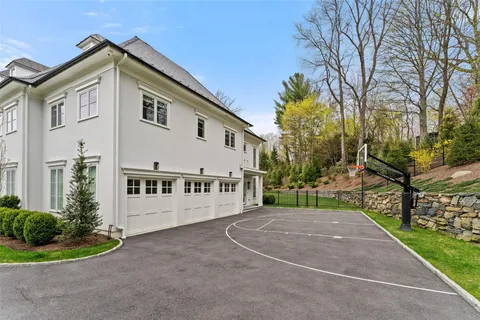a front view of a house with a yard and trees