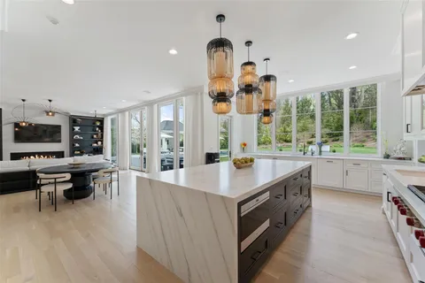 a open kitchen with stainless steel appliances granite countertop a sink and wooden floors